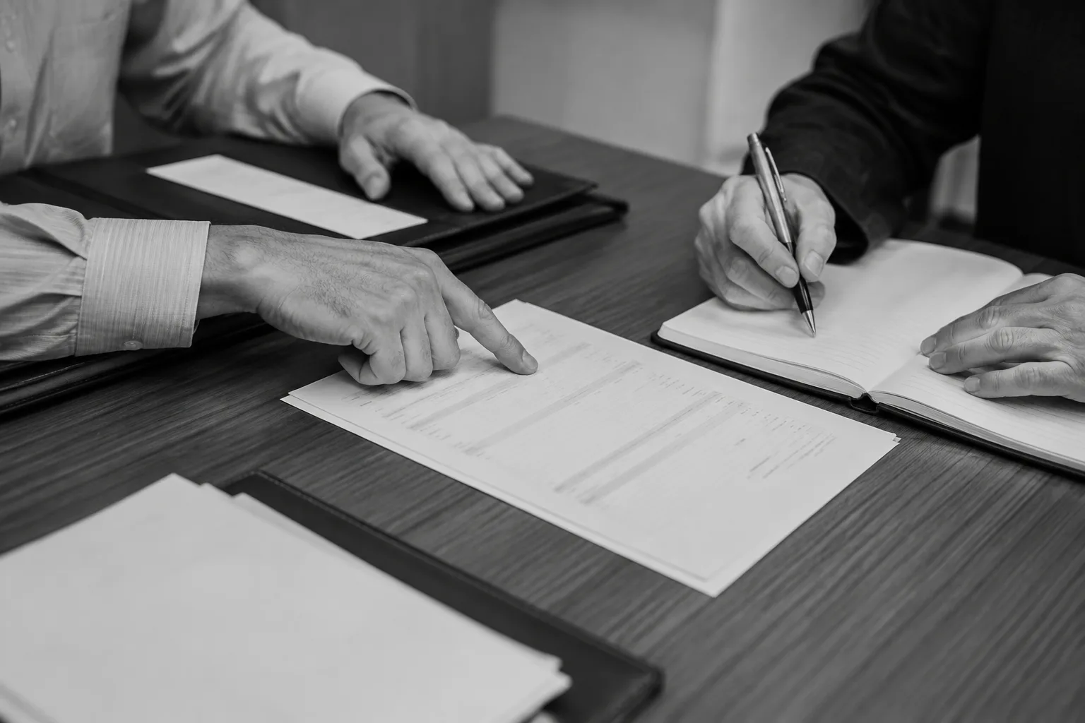 Hands reviewing documents during a debt resolution discussion